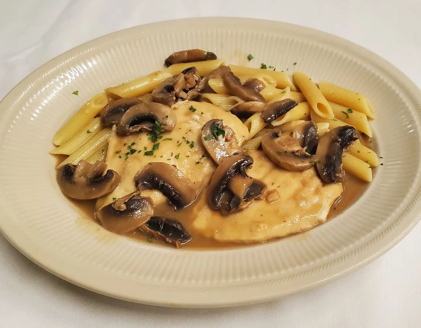 Chicken Marsala over pasta from A Touch of Italy