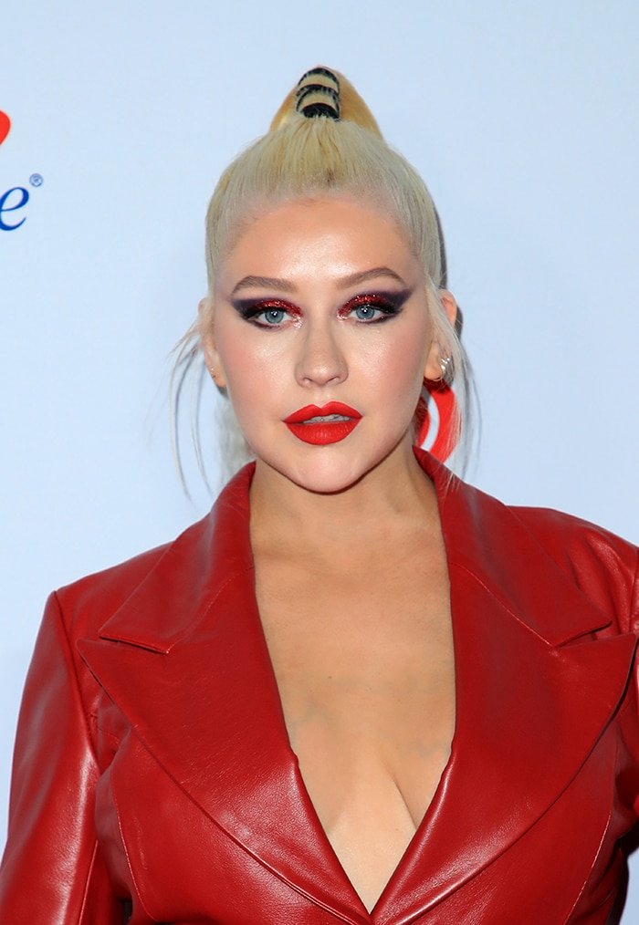Christina Aguilera goes bare in her 16Arlington crimson leather jacket at the iHeartradio Music Festival on September 21, 2019