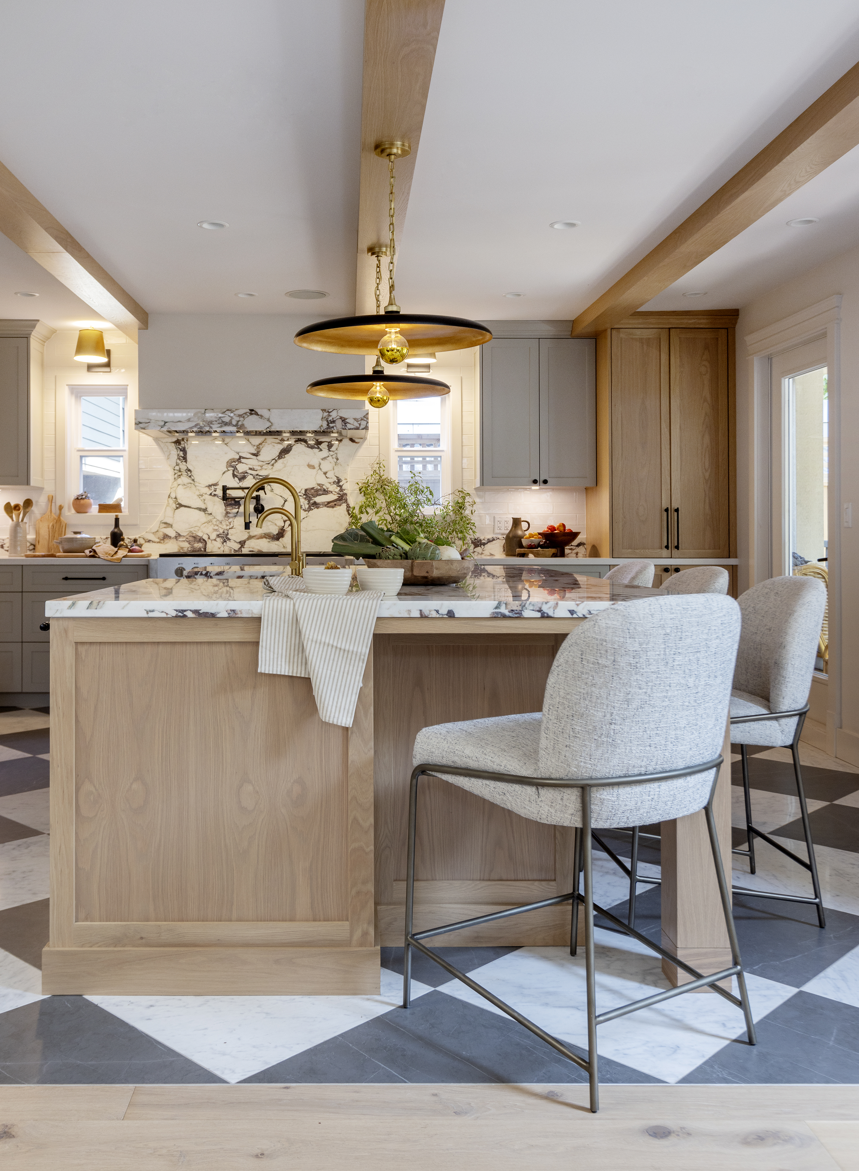 Kitchen with wood island and bar stools and checkerboard floor